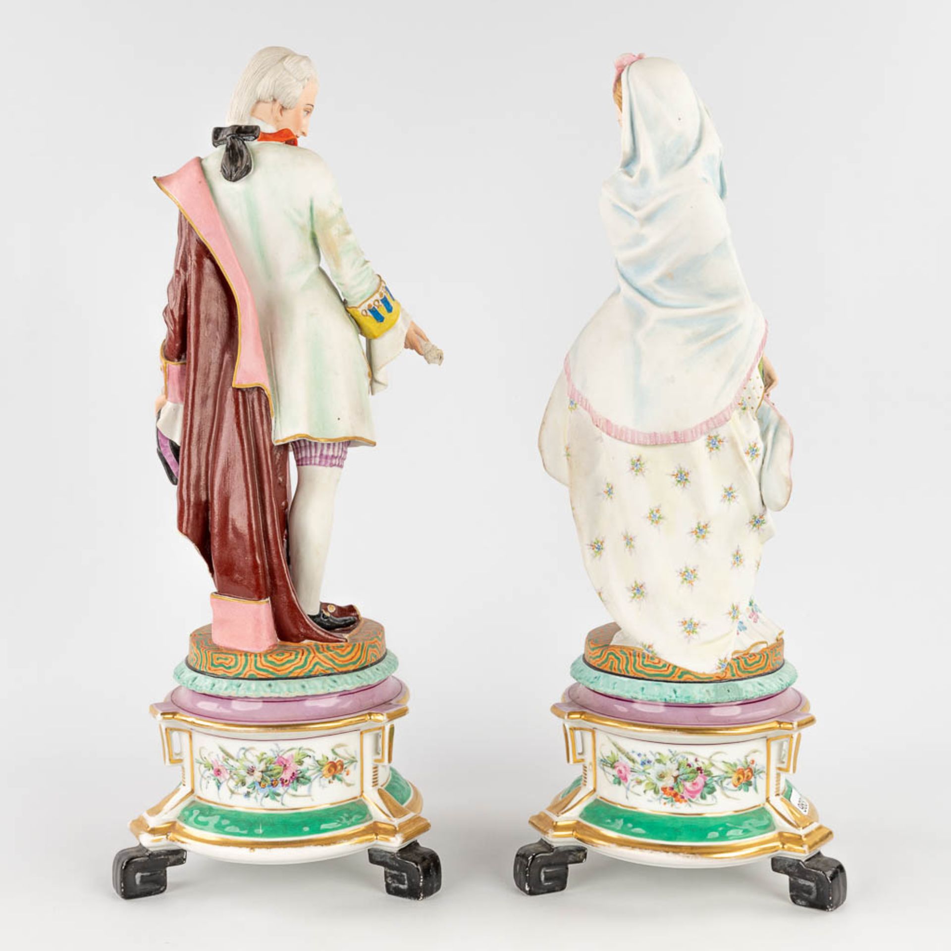 A pair of antique bisque figurines, standing on a glazed porcelain base. (L: 18 x W: 18 x H: 49 cm) - Image 4 of 24