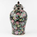 A Chinese 'Famille Noir' vase with lid and floral decor. 20th C. (H: 50 x D: 27 cm)