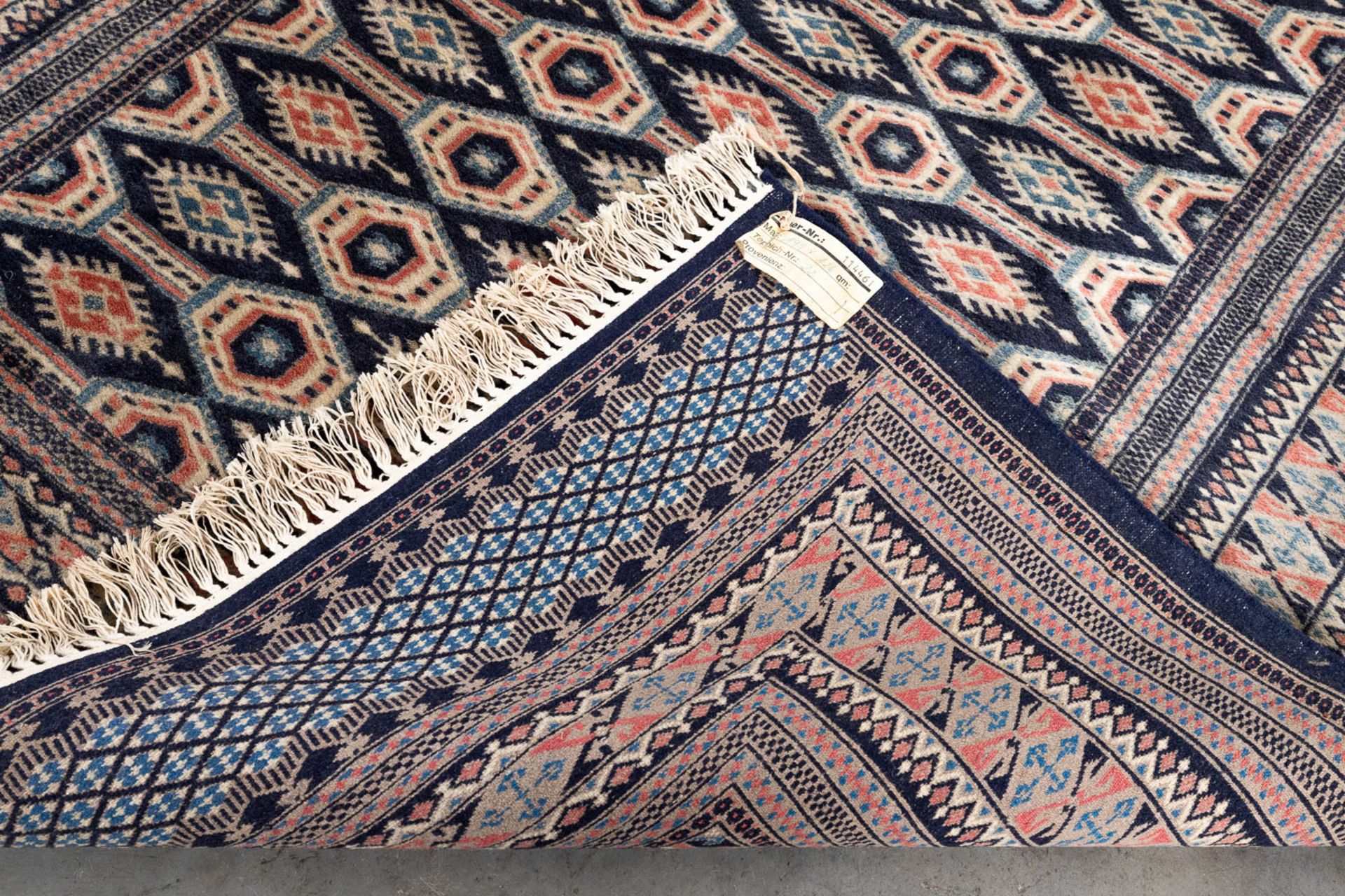 An Oriental hand-made carpet Buchara/Bokhara. (199 x 126 cm). (L: 199 x W: 126 cm) - Image 9 of 10