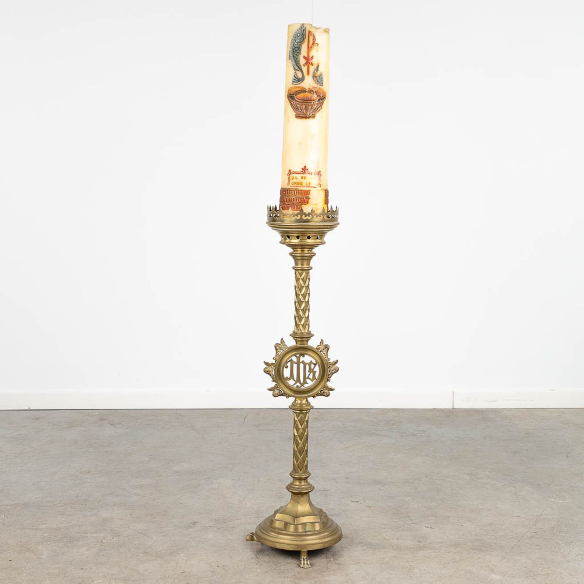 A large candlestick made of bronze, decorated with IHS logo. Gothic Revival style. (H: 92 cm)