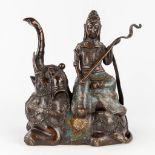 A figurine of Guanyin seated on an elephant, patinated bronze and champsleve enamel. 19th C. (L: 15