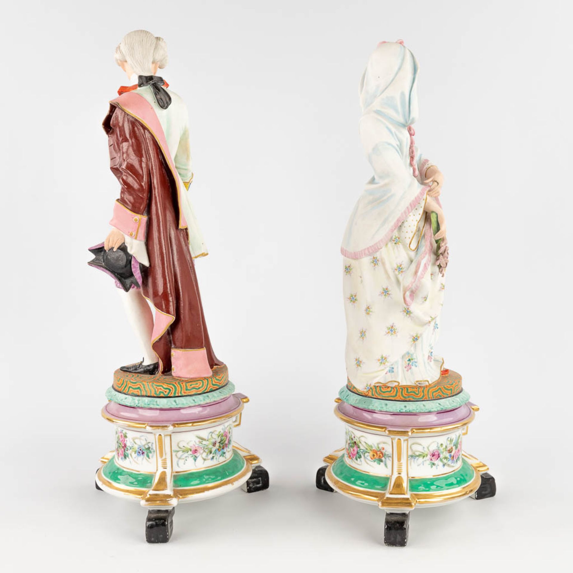 A pair of antique bisque figurines, standing on a glazed porcelain base. (L: 18 x W: 18 x H: 49 cm) - Image 5 of 24