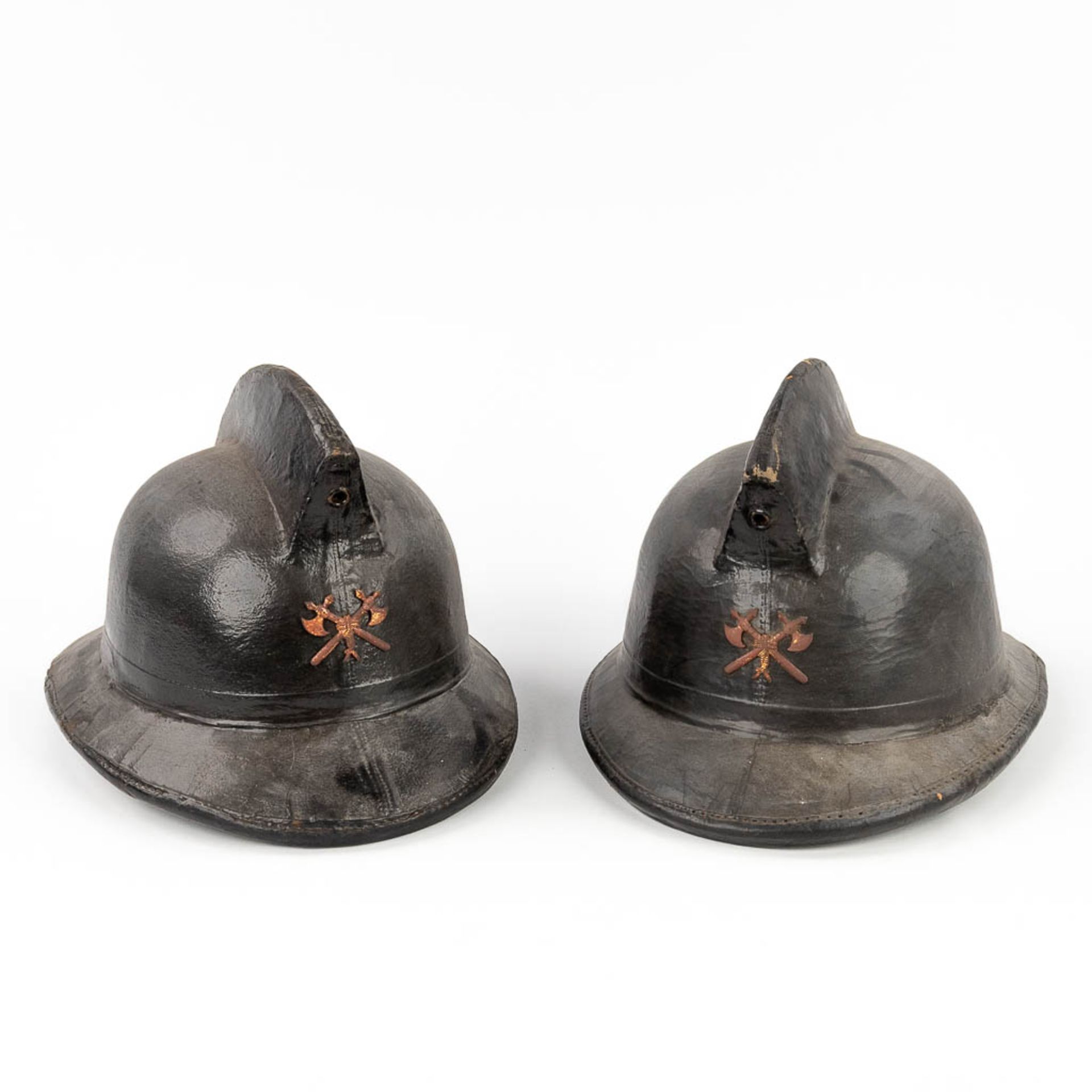 leviroLevior, a pair of antique helmets, made of leather. Marked Levior Depose. Circa 1920. (L: 37 x