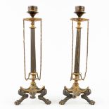 A pair of antique candlesticks, patinated and gilt bronze in empire style. 19th C. (H: 28 x D: 9 cm)