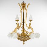 A chandelier made of gold-plated bronze, decorated with putti and glass in Louis XV style. Circa 195