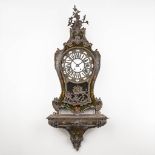 A Kartell clock on a stand, 'Thuret ö Paris' with hand-painted flower decor. (L: 25 x W: 56 x H: 144