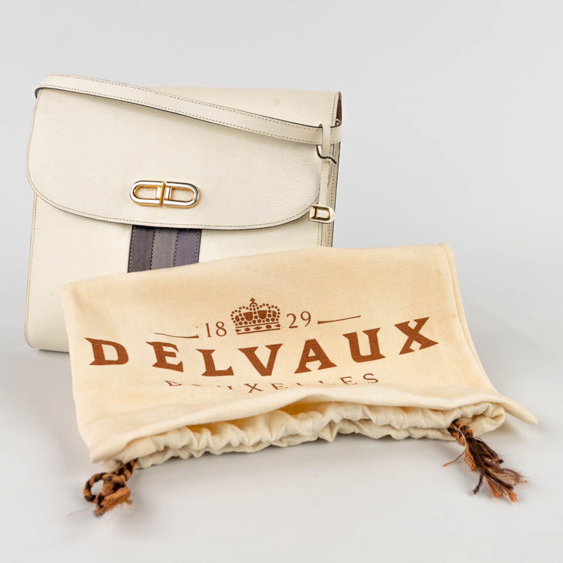 Delvaux, a handbag made of white leather decorated with colored stripes, and gold-plated hardware. ( - Image 3 of 18