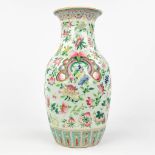 A Famille Rose Chinese vase with a hand-painted decor of flowers, peaches and butterflies. 19th C. (