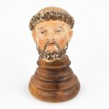 The head of a holy figurine, probably Saint Anthony. Sculptured wood with original polychrome (12,5c