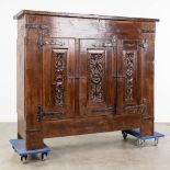 An antique three-door cabinet with sculptured oak doors, France, 17th C. (L: 55 x W: 175 x H: 151 cm