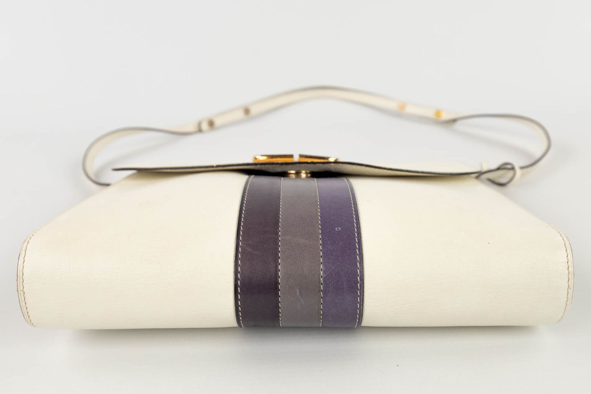 Delvaux, a handbag made of white leather decorated with colored stripes, and gold-plated hardware. ( - Image 10 of 18