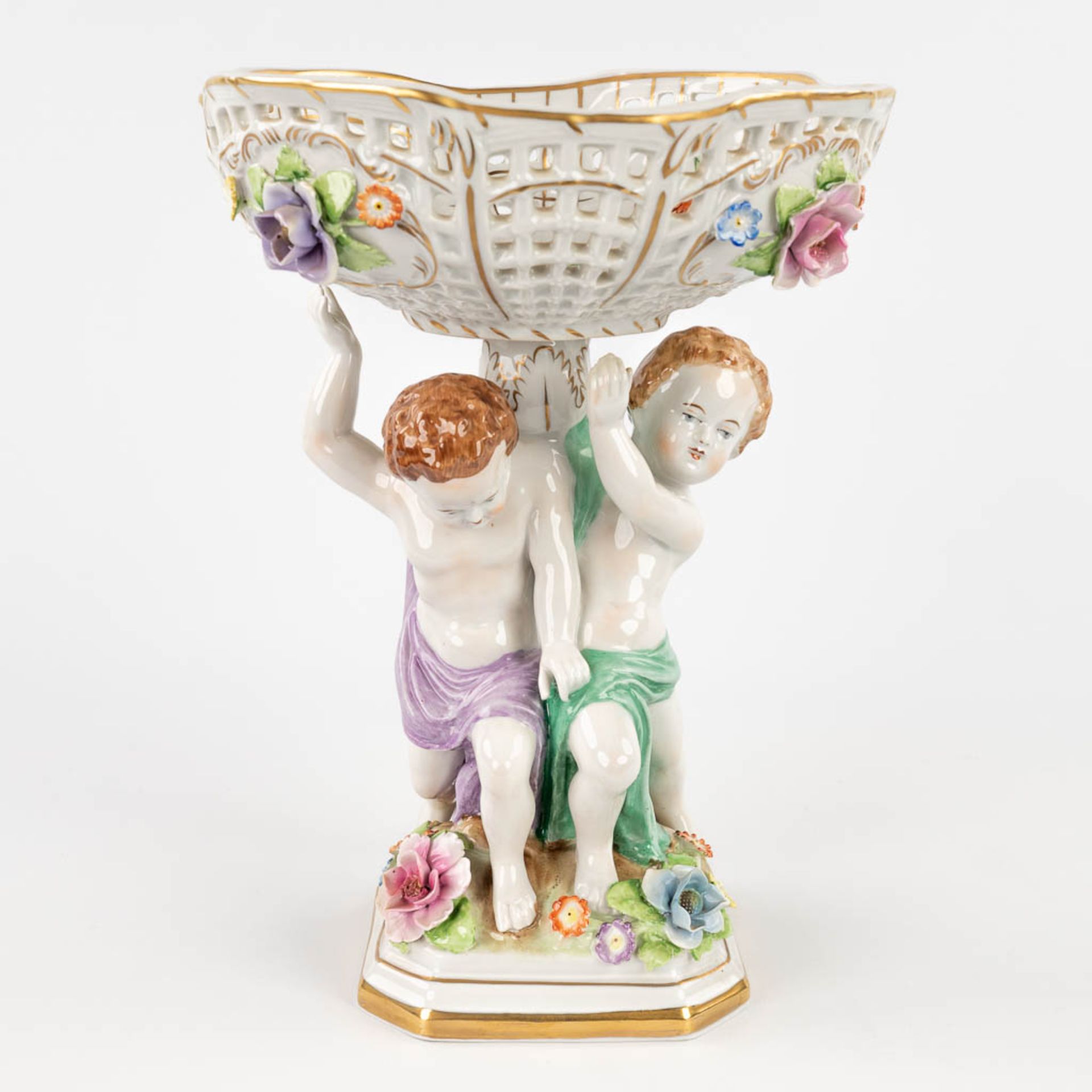 Plaue Schierholz 1817, a porcelain tazza decorated with boys holding up a basket. 20th C. (L: 19 x W