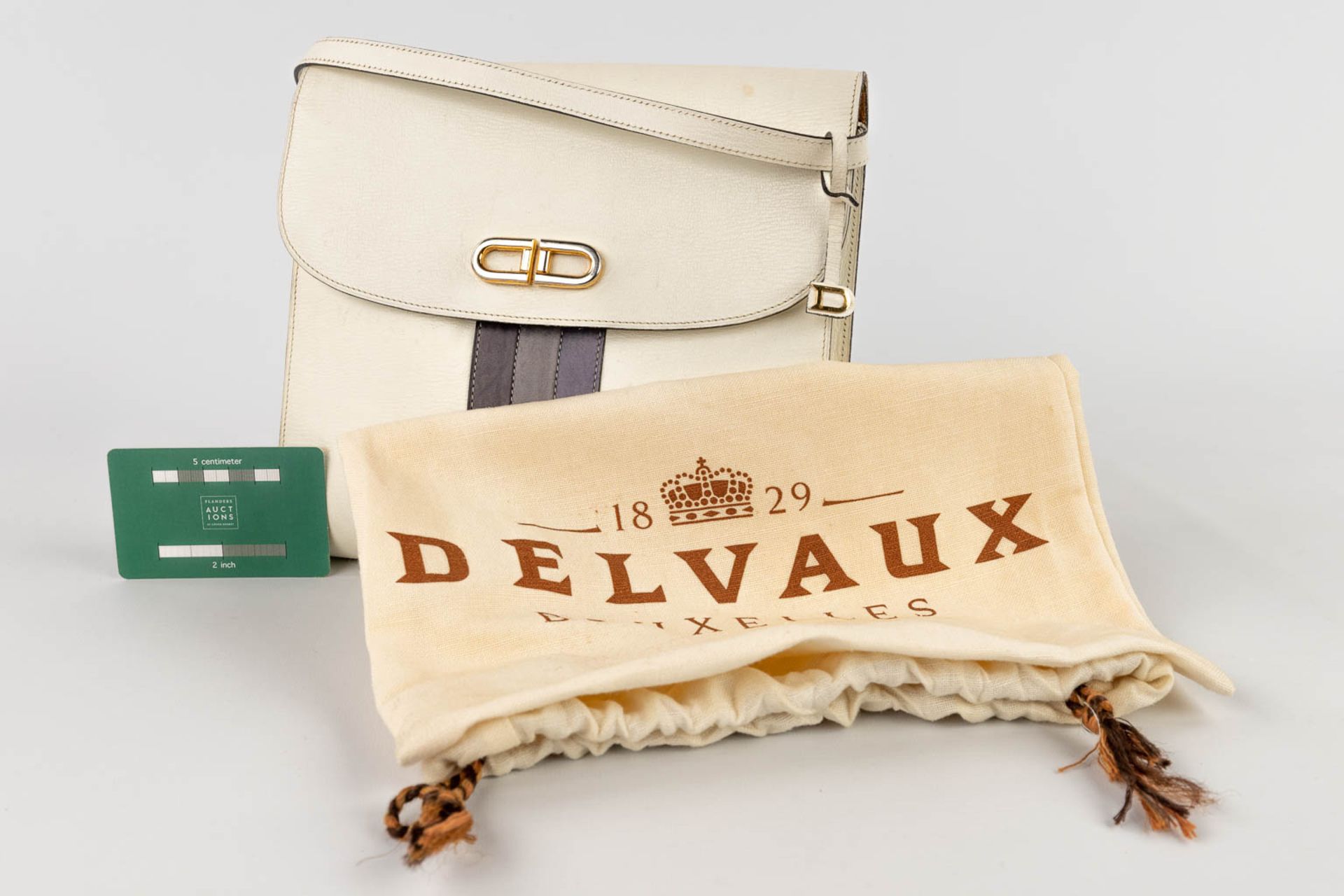 Delvaux, a handbag made of white leather decorated with colored stripes, and gold-plated hardware. ( - Image 2 of 18