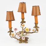 A table lamp, bronze, with porcelain figurine and flowers. Probably Germany. (L: 20 x W: 34 x H: 33