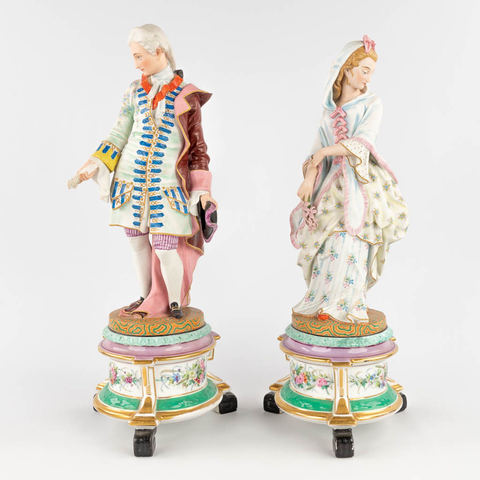 A pair of antique bisque figurines, standing on a glazed porcelain base. (L: 18 x W: 18 x H: 49 cm) - Image 7 of 24