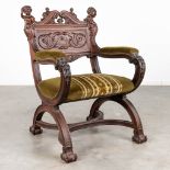 An armchair made of sculptured walnut in Italian renaissance style and finished with putti. (L: 70 x