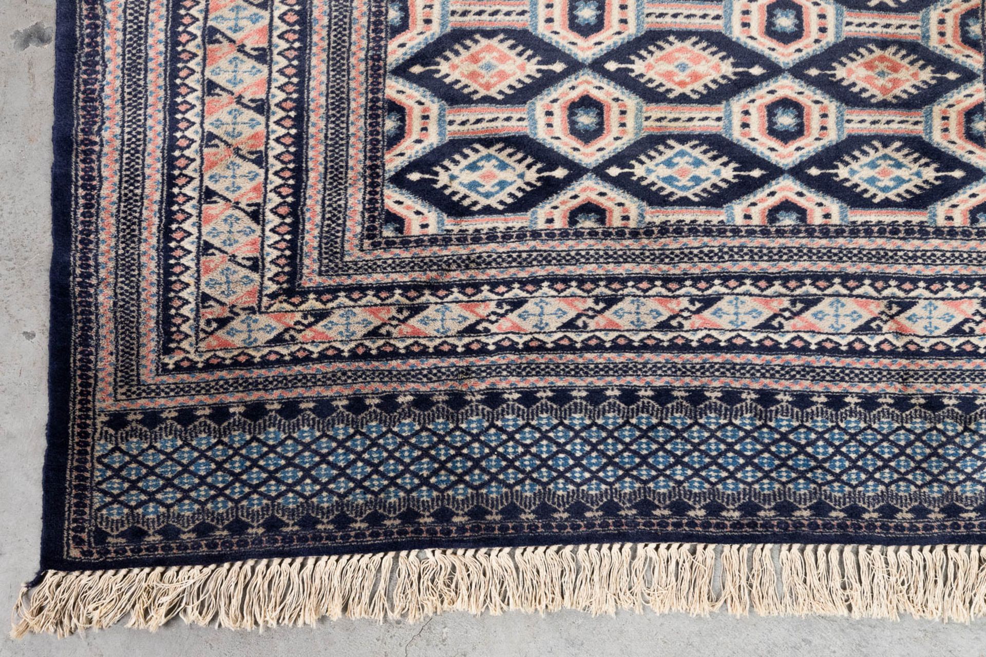 An Oriental hand-made carpet Buchara/Bokhara. (199 x 126 cm). (L: 199 x W: 126 cm) - Image 3 of 10