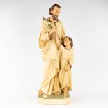 A large figurine of Joseph with Child, made of patinated plaster. Circa 1900. (H: 86 cm)