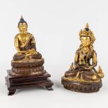 A collection of 2 Goldface Buddha's made of copper and bronze. (L: 16 x W: 13 x H: 25 cm)