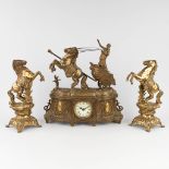 A three-piece mantle garniture clock with side pieces, bronze, decorated with horse figurines. 20th