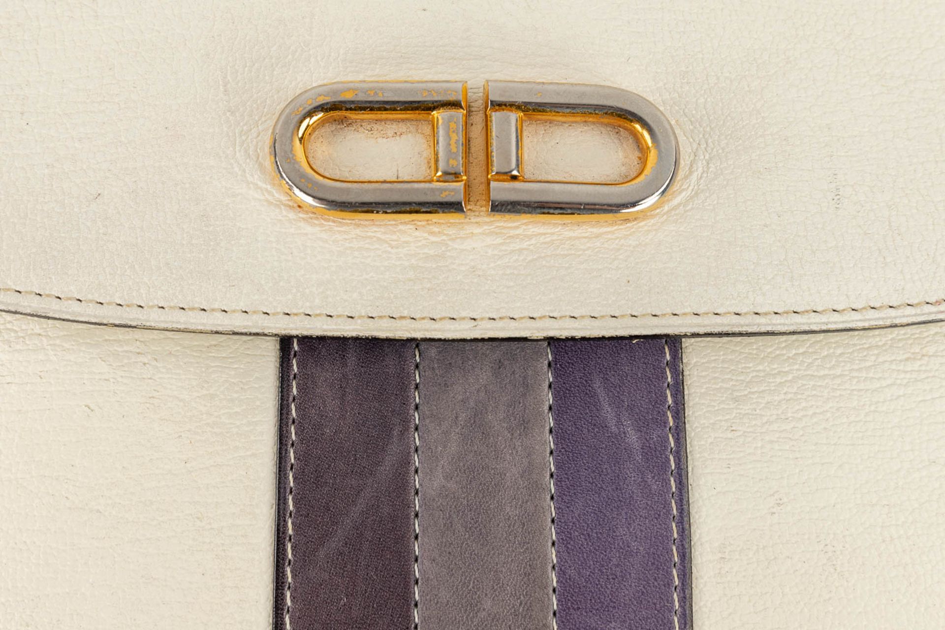 Delvaux, a handbag made of white leather decorated with colored stripes, and gold-plated hardware. ( - Image 11 of 18