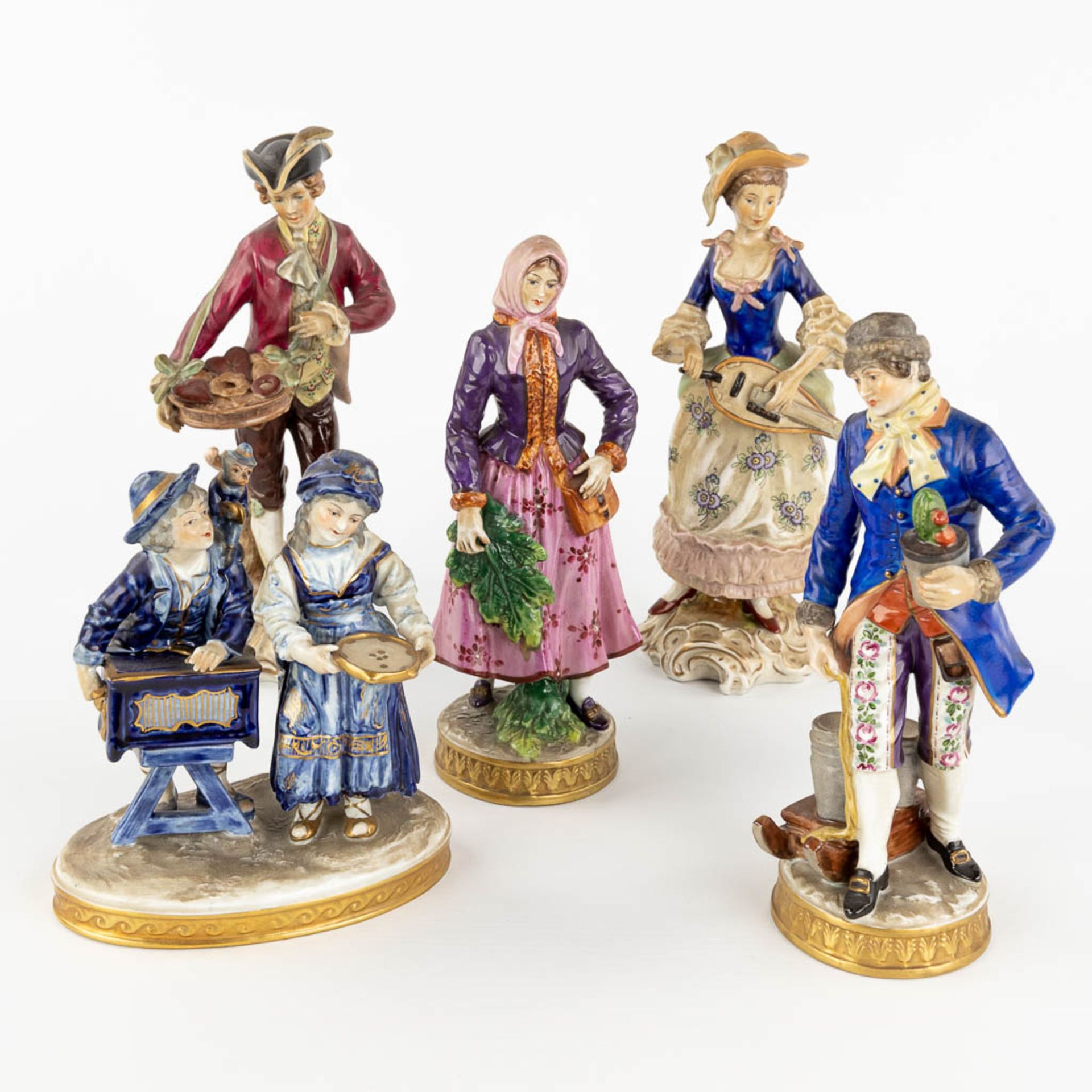 An collection of porcelain figurines. Marks by Volkstedt, Capodimonte. (H: 23 cm)