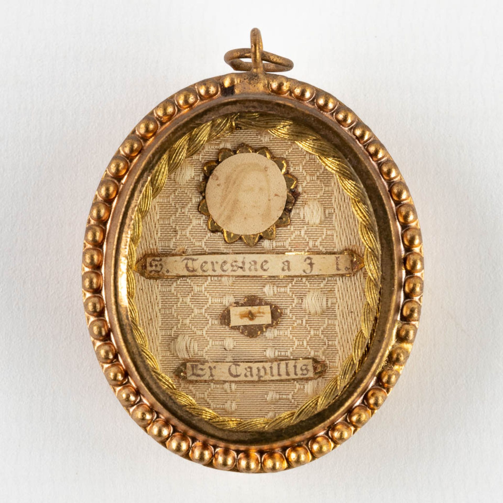 A sealed theca with a relic Ex Capilis S. Teresia ˆ Jesu Infante V. Thérse of Lisieux. (W: 37 x H:
