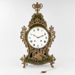 An antique Kartel clock, wood mounted with bronze and floral decor. Circa 1800. (L: 15 x W: 43 x H: