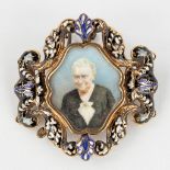 An antique brooch/stand, decorated with enamel and finished with a miniature painting. 18 karat gold