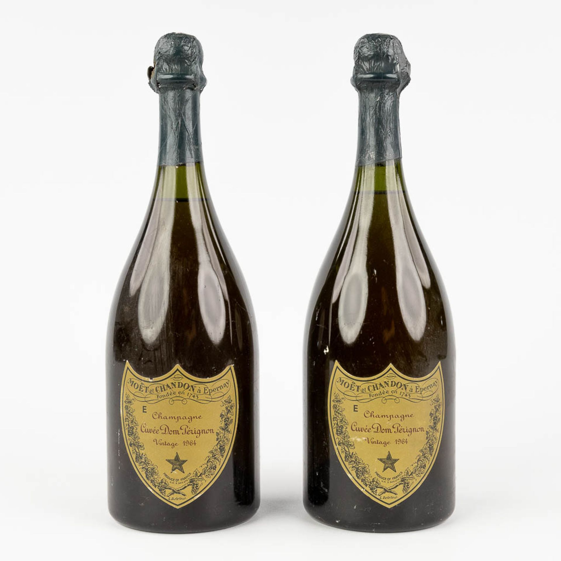 Dom Pérignom, a pair of Champagne bottles, 1964. (H: 30 cm)