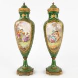 Svres, a pair of green vases with hand-painted decor and mounted with bronze. (H: 37 x D: 10,5 cm)
