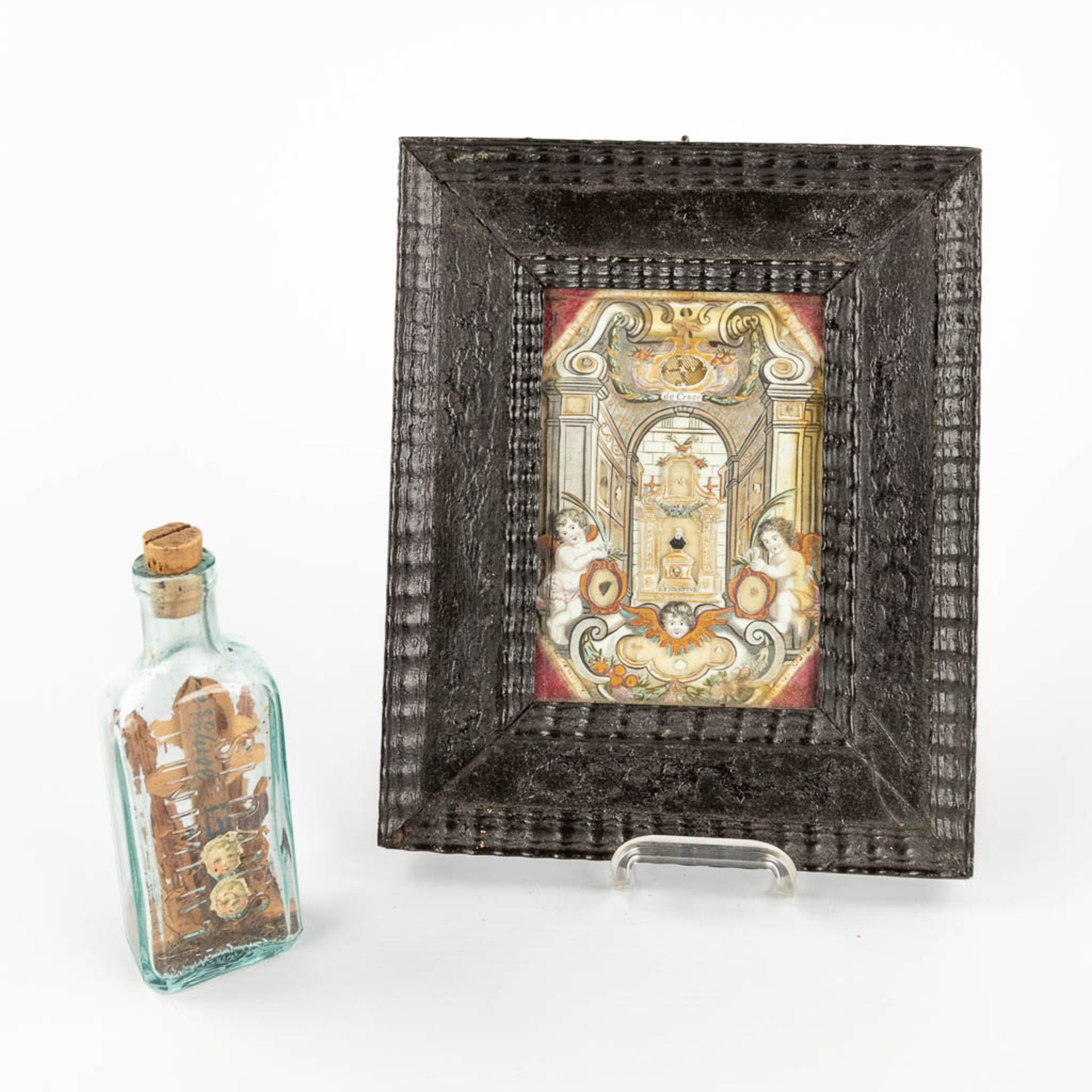 A reliquary frame, De Cruce and S. Pignativs, added a bottle with crucifix. 19th C. (W: 18 x H: 22 c