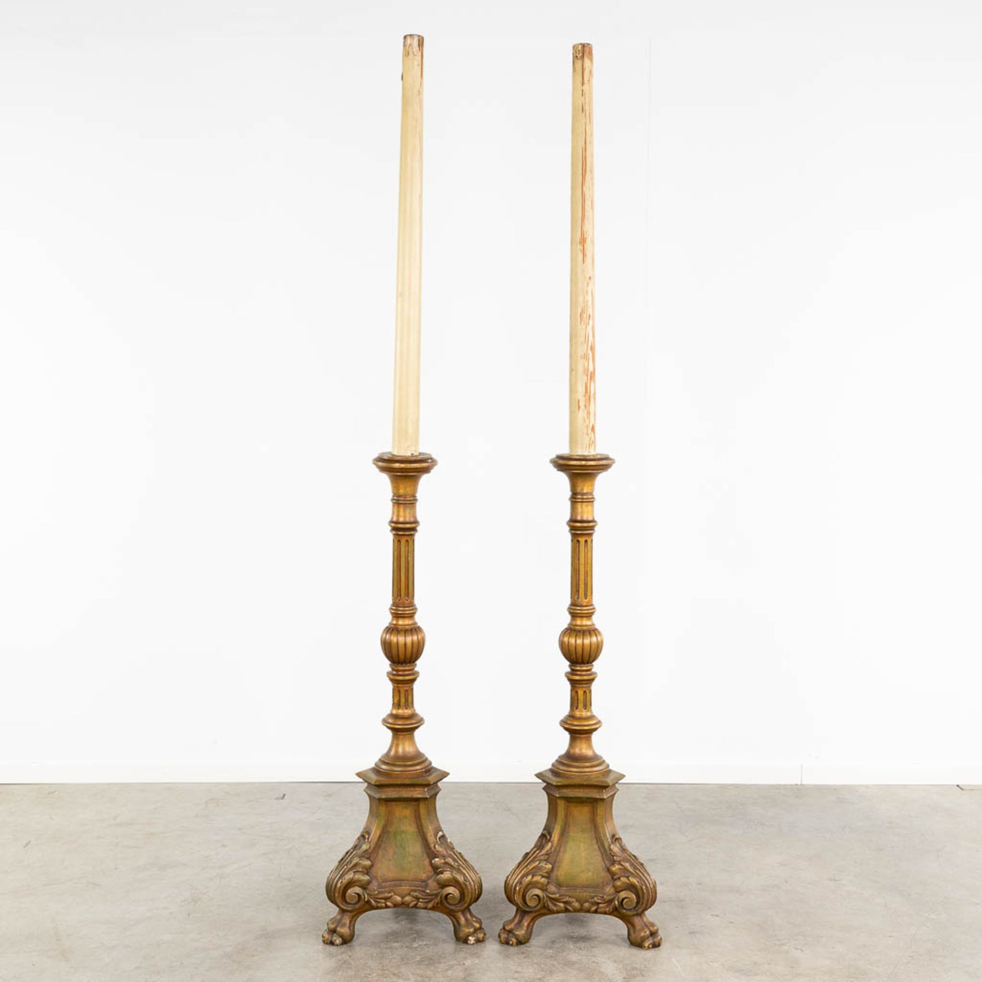 A pair of wood-sculptured church candlesticks. 19th C. (L: 41 x W: 41 x H: 219 cm)