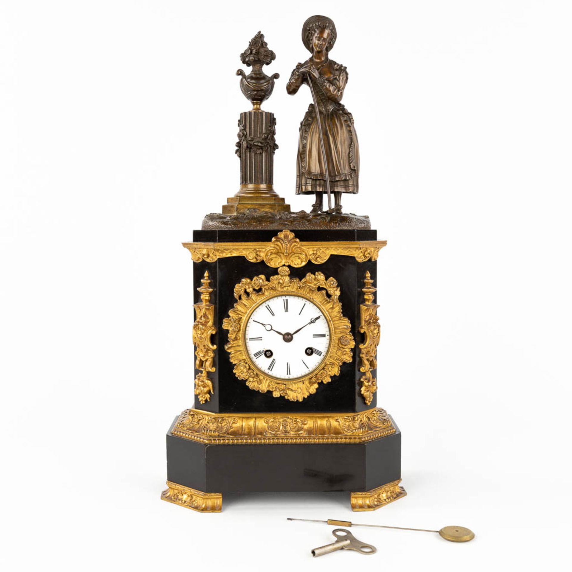 A black marble and bronze mantle clock 'Lady with a rake' 19th C. (L: 12 x W: 22,5 x H: 44 cm)