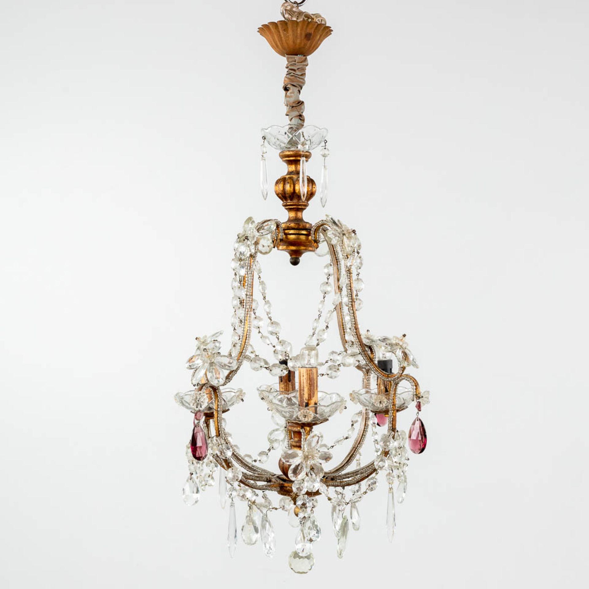 A decorative chandelier, brass and coloured glass. (H: 65 x D: 36 cm)