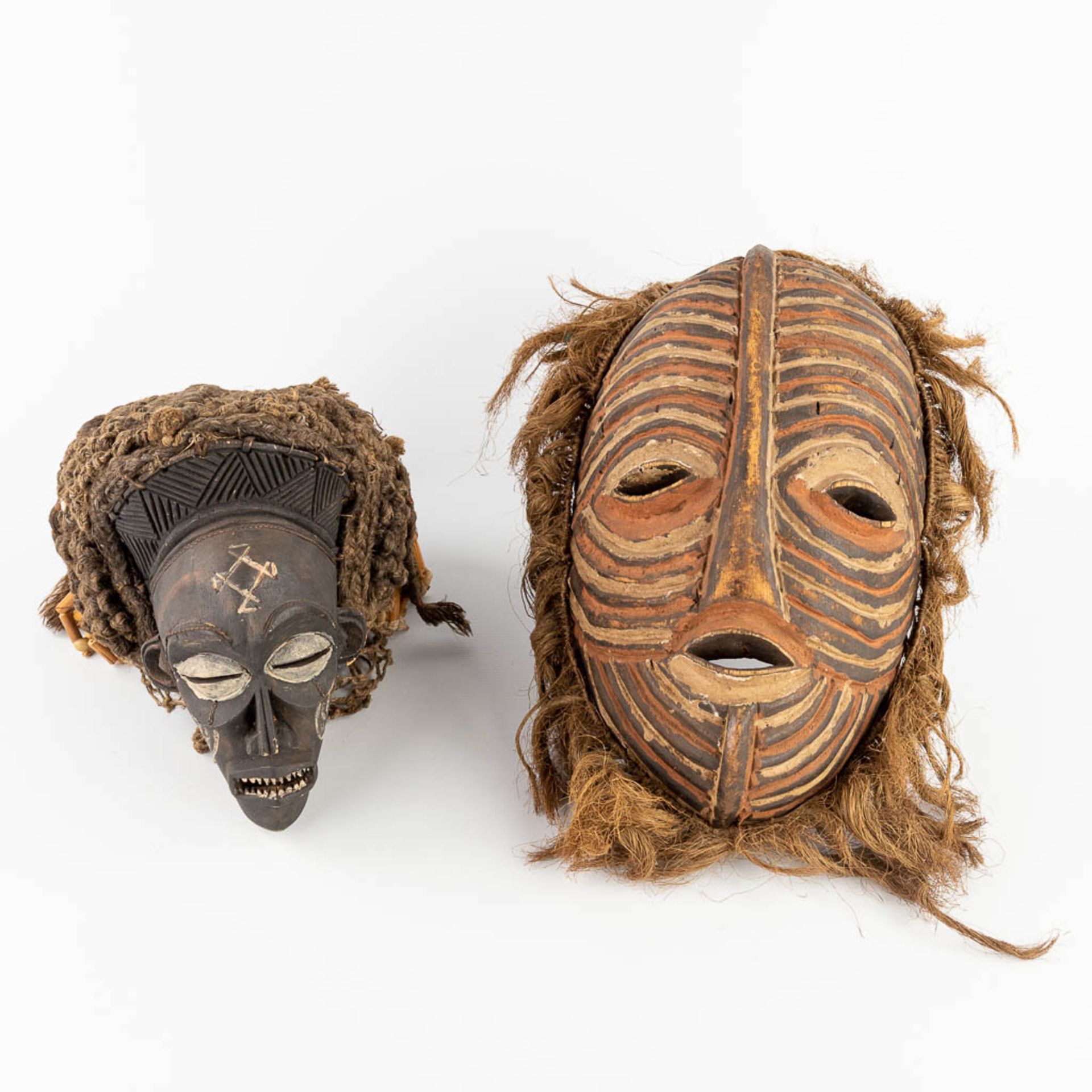 A collection of 2 African masks 'Chokwe' and 'Luba Songye'. (L: 13 x W: 24 x H: 43 cm)