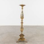 A church candlestick, brass, standing on claw feet. 20th century. (L: 31 x W: 31 x H: 109 cm)