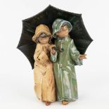 Lladro, 'Under The Umbrella' a figurine made of glazed stoneware. (L: 10 x W: 20 x H: 24,5 cm)