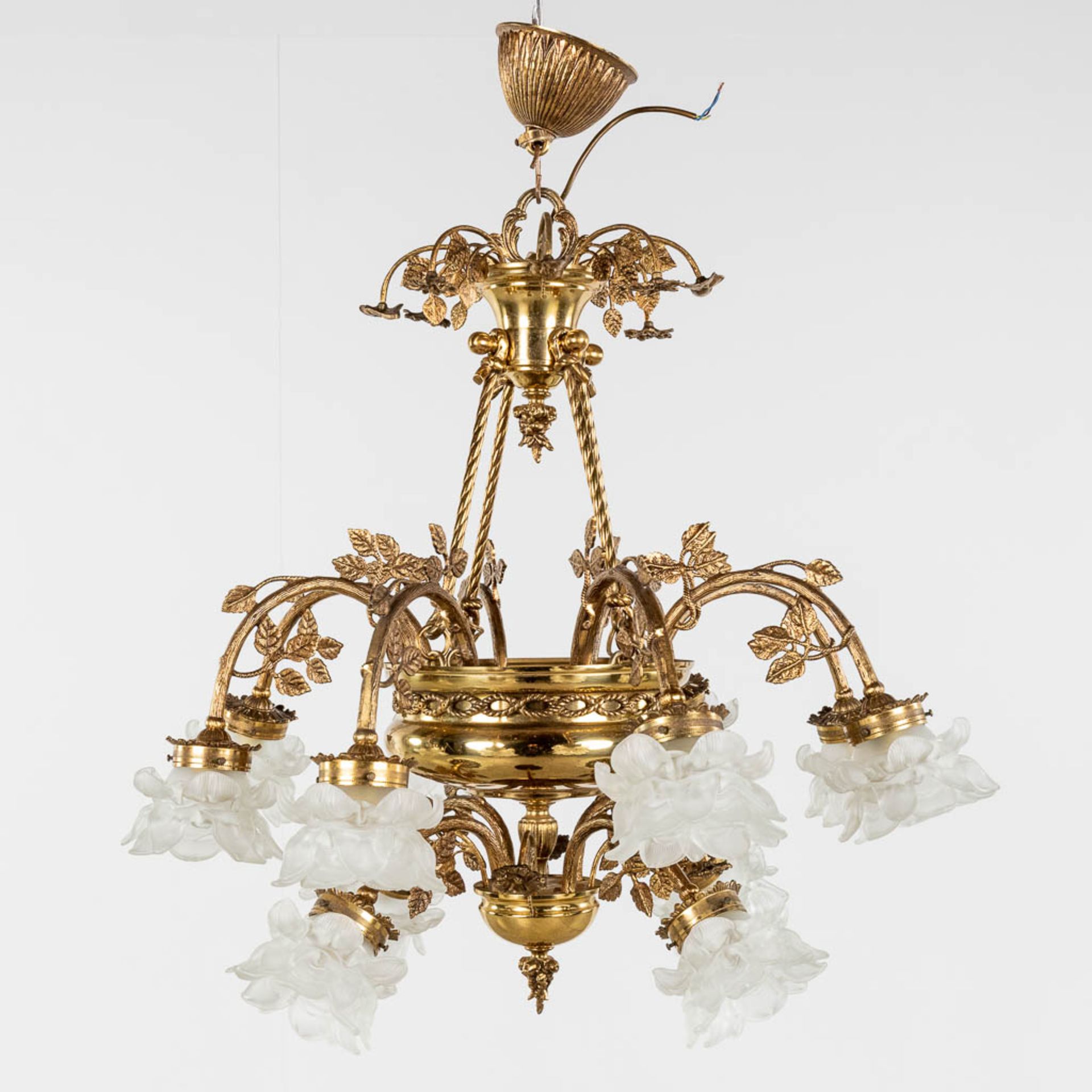 A chandelier, brass with glass lampshades. Circa 1970. (H: 85 x D: 85 cm)