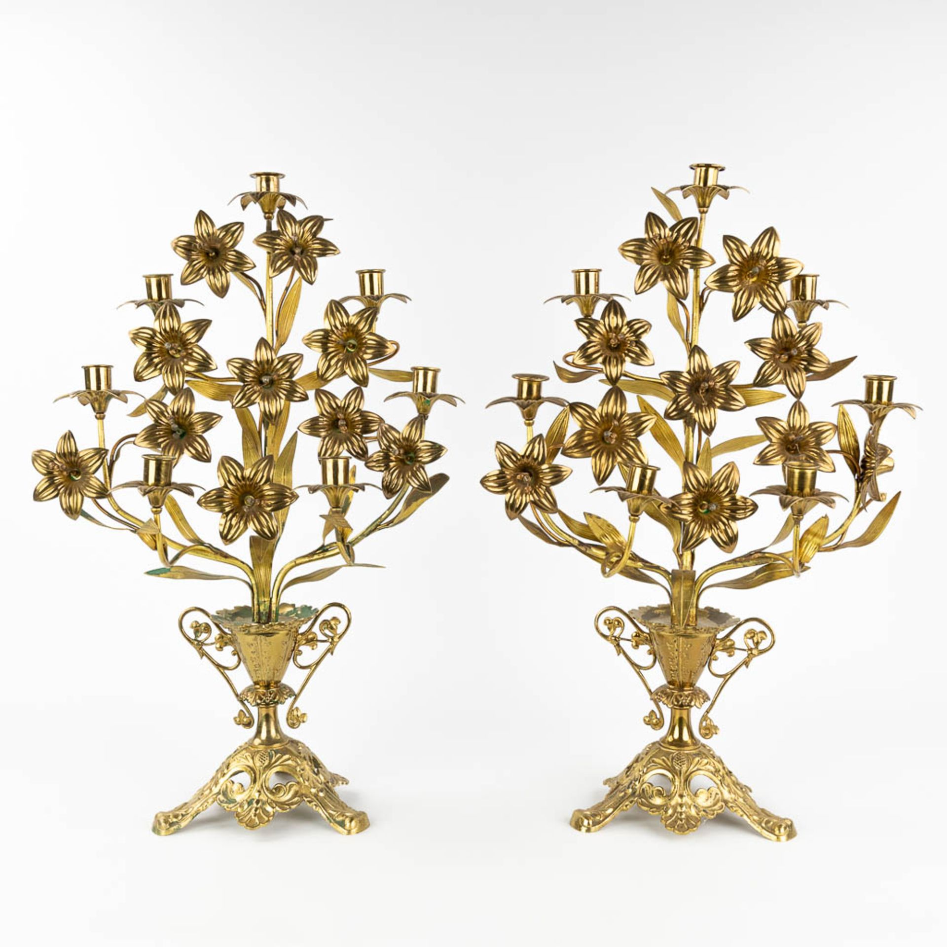 A pair of Church candlesticks, bronze and decorated with flowers. (L: 23 x W: 38 x H: 53 cm)