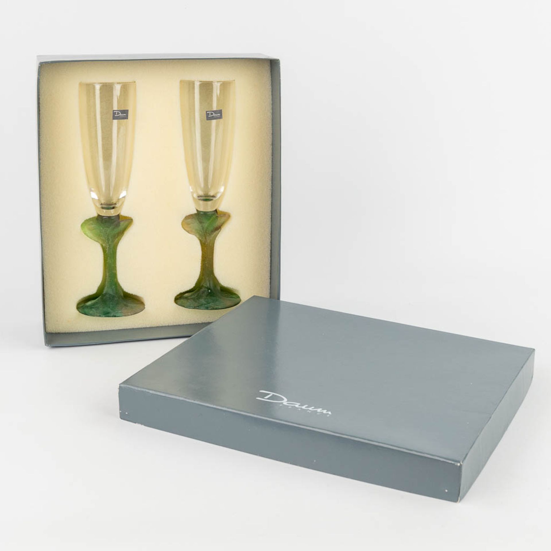 Daum France, 'Nature' a pair of champagne glasses in the original box. (H: 24 x D: 7 cm)