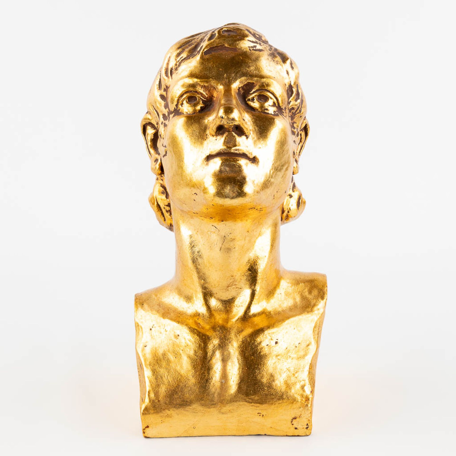 A gold-glazed terracotta buste, marked G. De La Soit. 1931. (L: 17 x W: 14,5 x H: 28 cm)