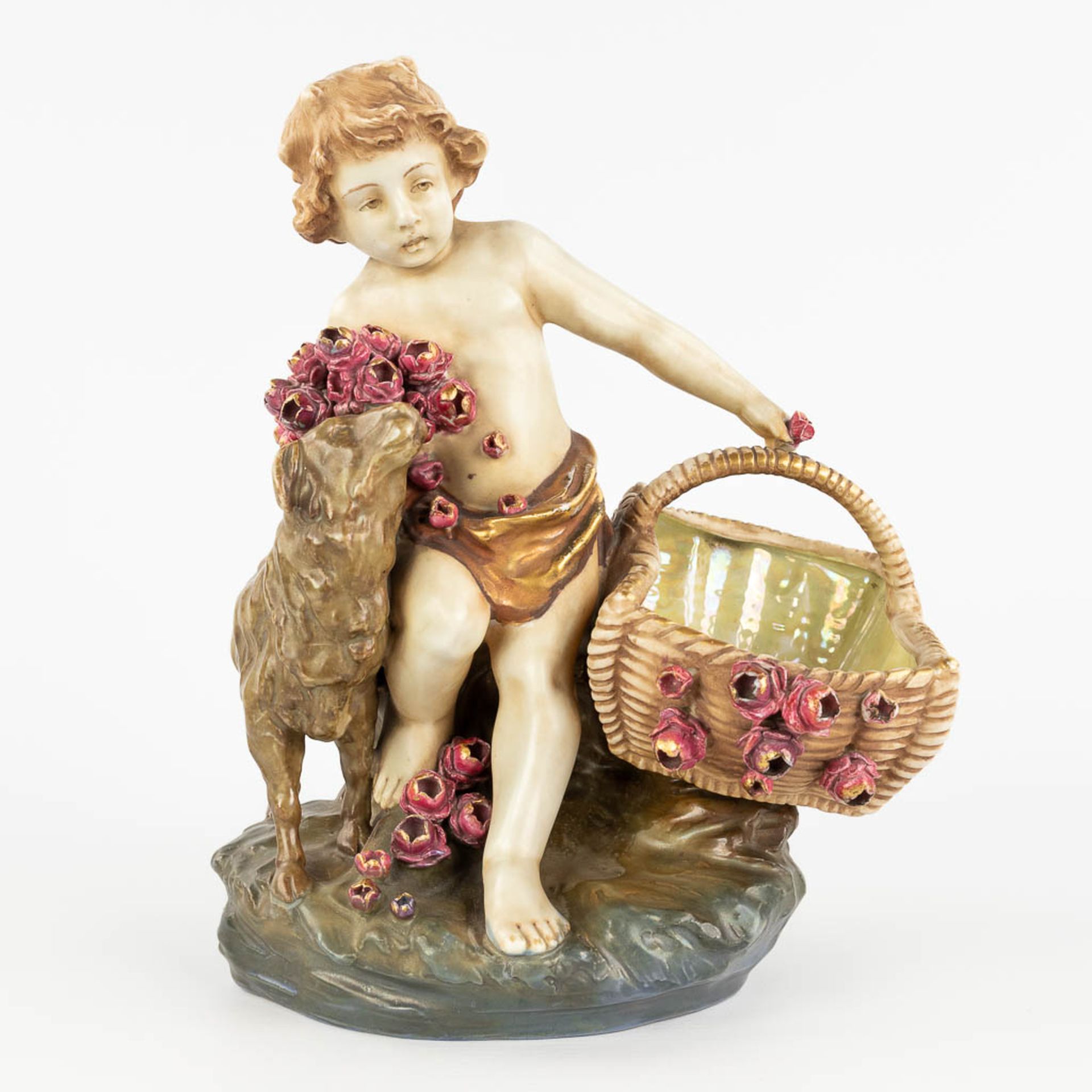 Amphora Austria, 'Child with a basket and sheep' made of glazed faience. (L: 18 x W: 24 x H: 29,5 cm