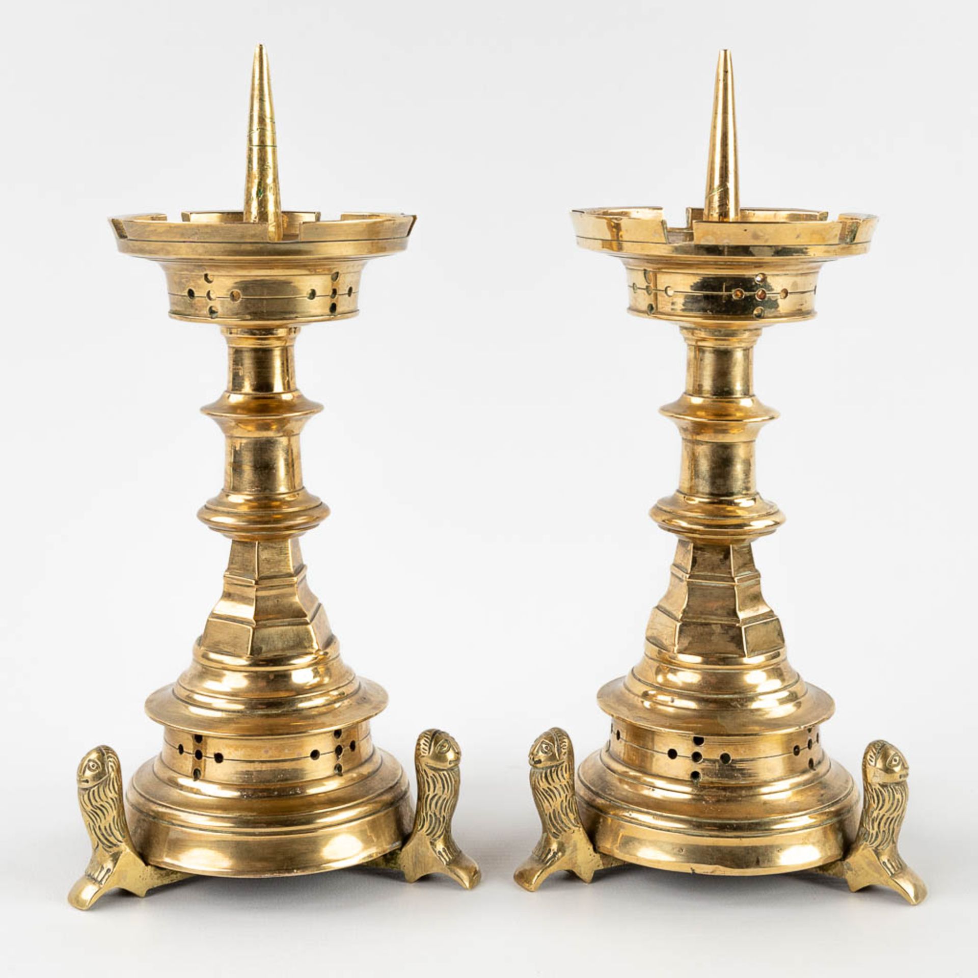 A pair of church candlesticks, bronze standing on lion's. 19th C. (H: 25 x D: 12 cm)