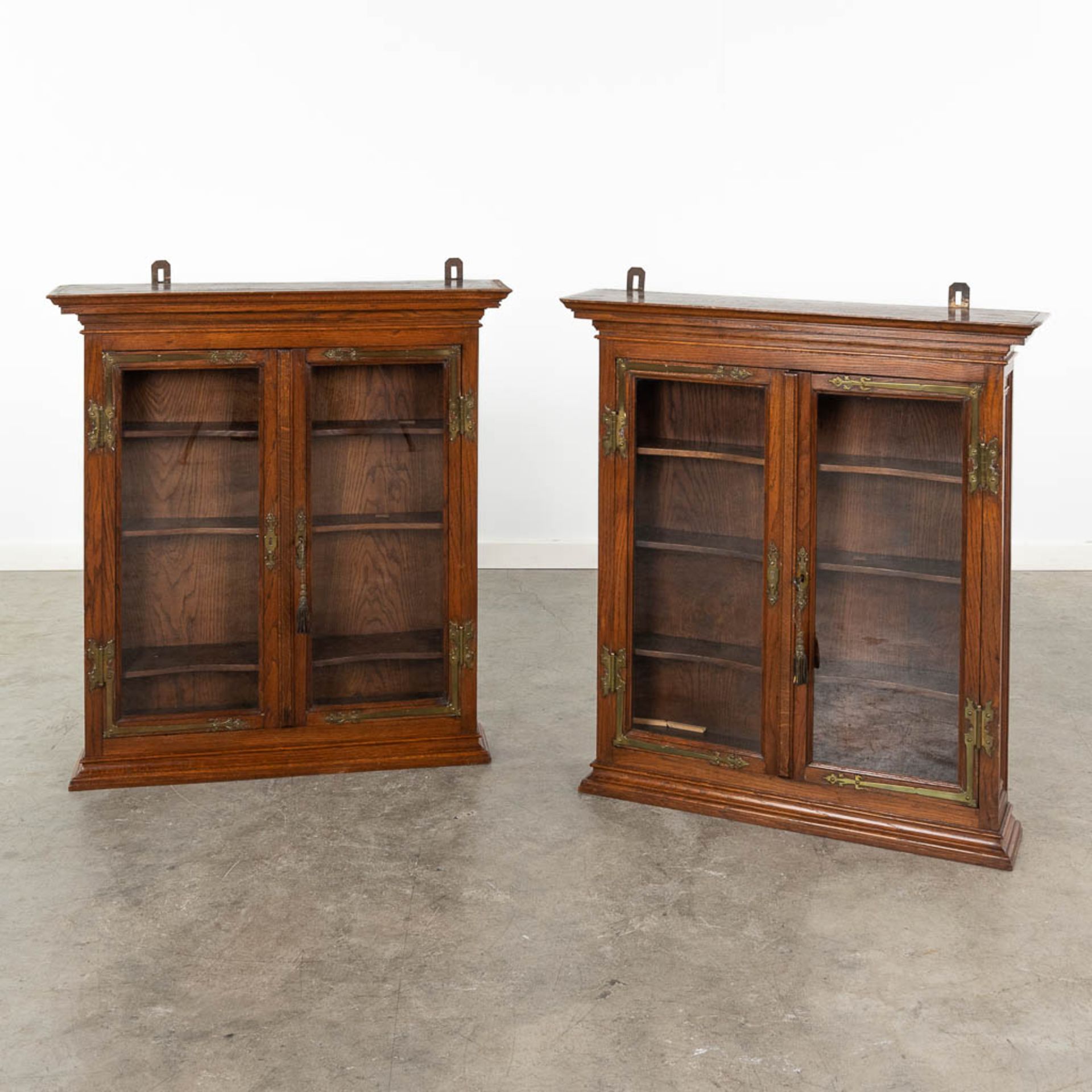 A pair of hanging cabinets, wood and glass. Circa 1900. (L: 17 x W: 75 x H: 83 cm)