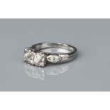 A White Precious Metal and Diamond Ring,