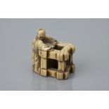 An Edo Period Ivory Netsuke as a Karako with Box Crate,