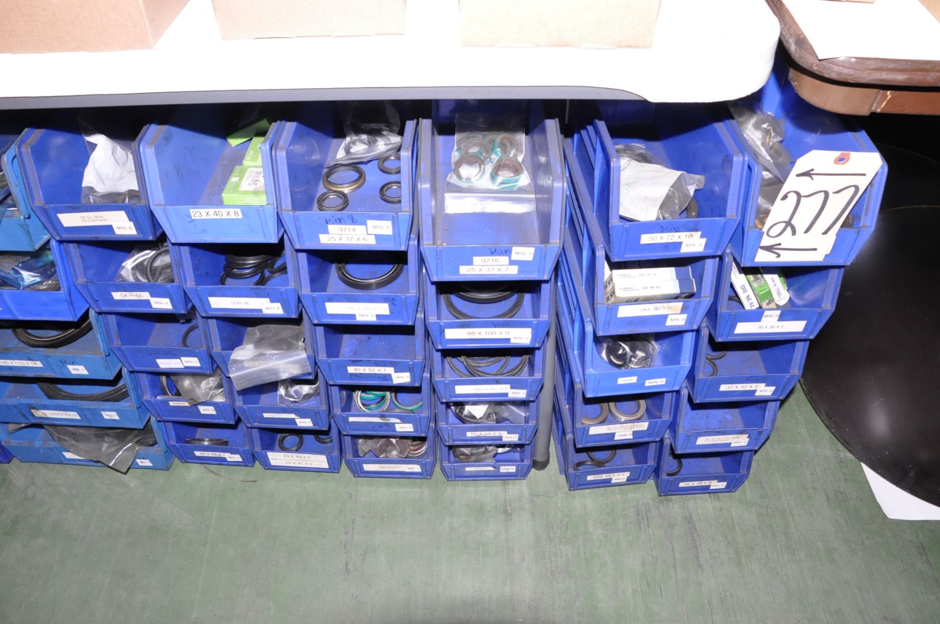 Lot-Various Bearing Seals in Blue Parts Bins on Floor Under (3) Tables, (E-3)