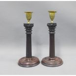 Pair of mahogany corinthian column candlesticks with gilt brass capitals and detachable scones, 27cm