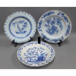 Three antique Delft chargers, each with blue and white floral pattern, rim edge fritting and